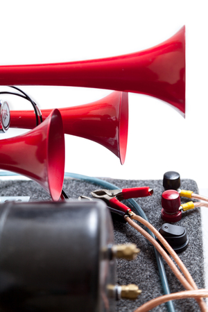 Modern horn. Pneumatic horn with three red tubes stands on a close-up standの写真素材