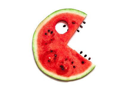 Funny fantastic silhouette with an eye and opened mouth with teeth. A delicious slice of red ripe watermelon lies on a white background.の写真素材