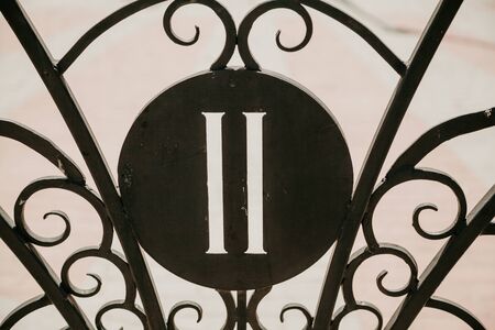 Roman numerals. The number 2 in the Roman script is cut on a round metal product. Around forged...