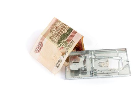 Money as bait. Money bill with a hole inserted into a metal mousetrap on a white background