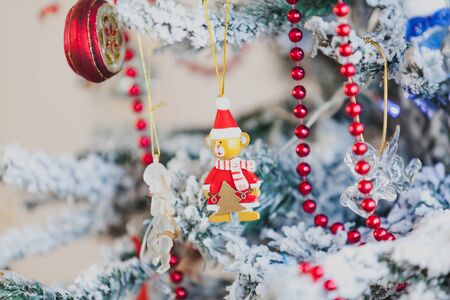 original Christmas tree toy weighs on the New Year tree. Near the red garland