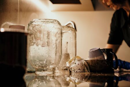 inverted glass jar stands on a marble worktop. In the foreground is a wet towel.