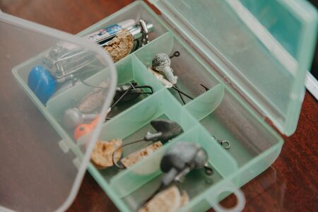 Lures for catching predatory fish. Jig heads with hooks lie in a special transparent box with...