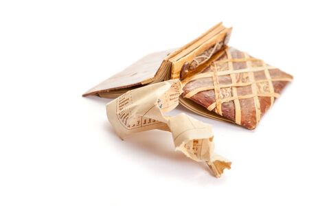 open notebook with a botanical cover design lies on a white background. Nearby lies a crumpled torn...