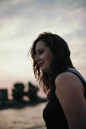 Portrait of a pretty girl with long red hair on a blurred background. Woman portrait without...