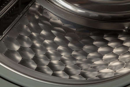 Interesting geometric texture. Fragment of a stainless steel centrifuge wheel of a modern washing...