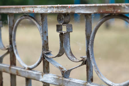 An element of an old fencing with a marine theme. An anchor figure of a thin metal strip adorns the old grill. Side viewの写真素材