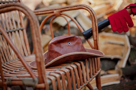 brown leather hat rests on a rattan wicker chair. Close-upの写真素材