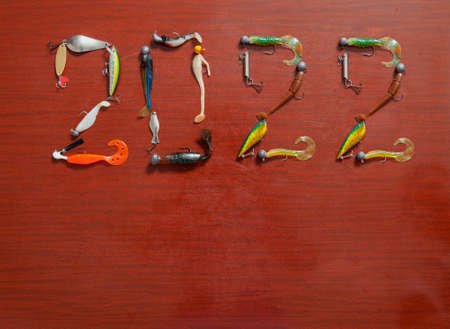 year of the fisherman. Year number 2022 composed of uniquely designed numbers of spoon, plug and...