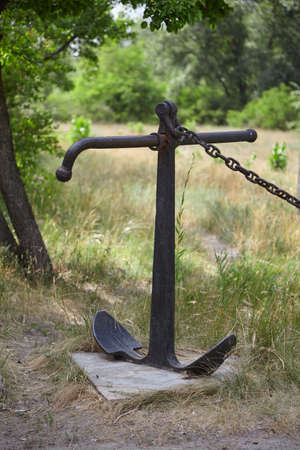 Monument to the anchor in the steppe. A real Admiralty anchor with a chain is installed vertically...
