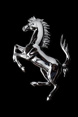 The chrome-plated horse stands on its hind legs against a black background. beautiful tail raised highの写真素材