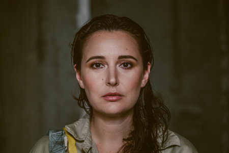 Portrait of a beautiful woman in a gray jumpsuit. A female portrait without retouching with her...
