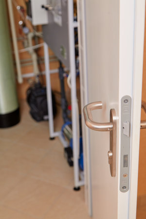 Modern design metal handle on an interior doorの写真素材