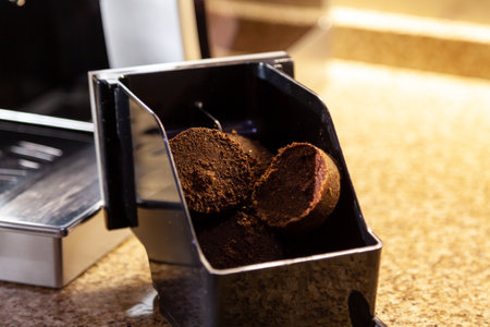 Compressed coffee briquettes are in the plastic container of the coffee machine. close-upの写真素材