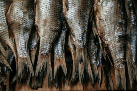 Fish tails. The group of dried fish lies on the counter in the market close-upの写真素材
