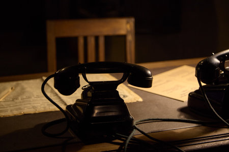 Antique rotary telephone stands in the dark officeの写真素材