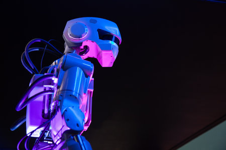 A mechanical cyborg robot with a large, oblong head on a black background.の写真素材