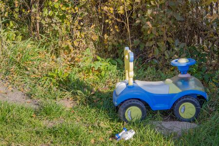Blue toy car in a country house, in the summer on the green grass.の写真素材
