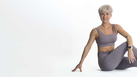 Beautiful sporty woman sitting resting after fitness exercises. COPY SPACE.
