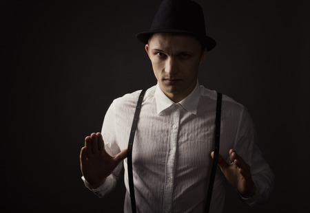 Man wearing white shirt and suspenders over black background
の写真素材