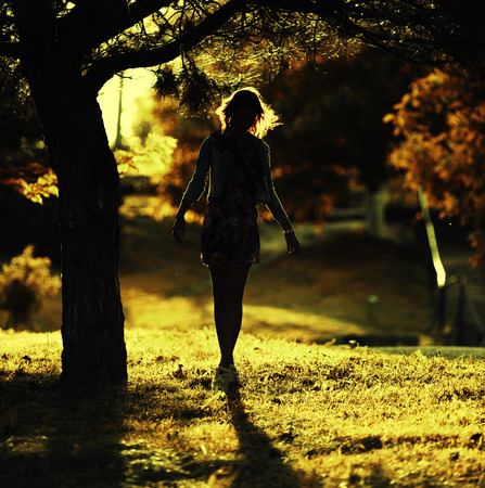 Woman stay under the tree and watching a sunrise. Vintage colorsの写真素材