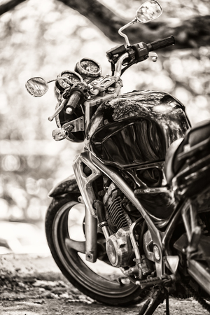 Vintage photo of a parked beside the road bike.Vintage sepia  effect added for create atmosphereの写真素材