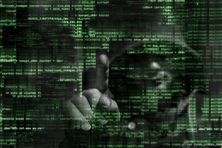 Silhouette of a hacker on graphic user interface