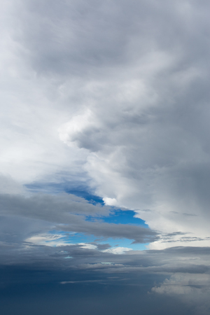 Aerial view on clouds and blue sky from airplane window