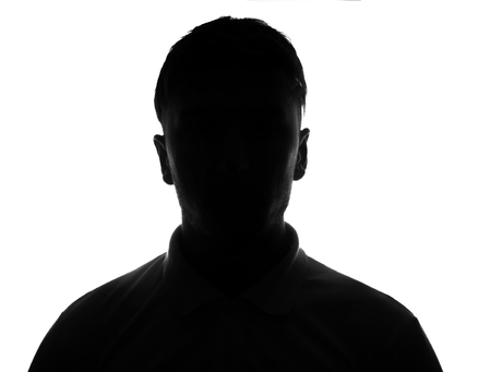 Hidden face in the shadow.male person silhouetteの写真素材