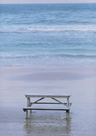 Wooden bench in front of the seaの写真素材