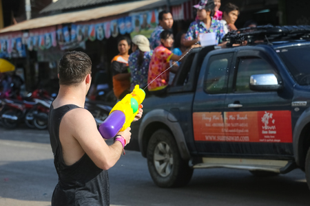 Koh Phangan island, Thailand - April 13 2017: Unidentified tourists shooting water on Songkran Festival ( Thai New Year ) at Thongsala streetsのeditorial素材