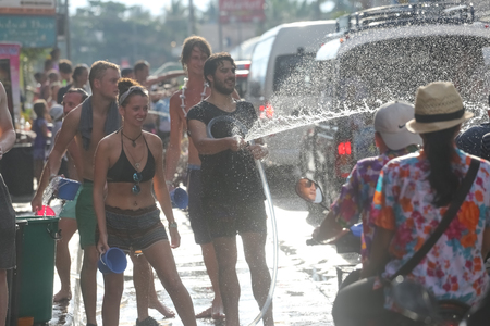 Koh Phangan island, Thailand - April 13 2017: Unidentified tourists shooting water on Songkran Festival ( Thai New Year ) at Thongsala streetsのeditorial素材