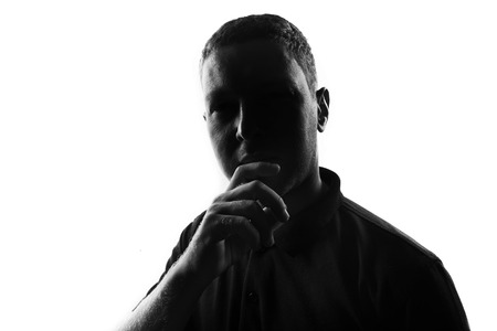 Silhouette of thinking man over white backgroundの写真素材