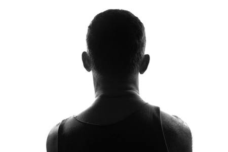 Male person silhouette,back lit over whiteの写真素材