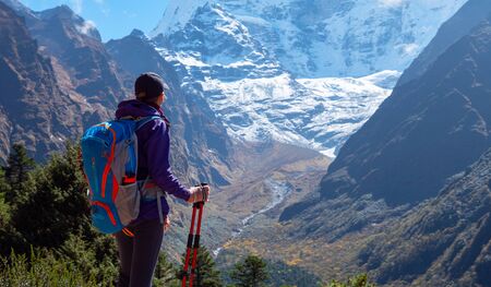 Active hiker hiking, enjoying the view, looking at Himalaya mountains landscape. Travel sport...
