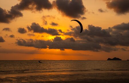 Kitesurfing, action sport in twilight at sunset timeの写真素材