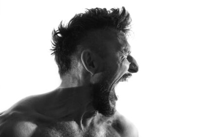 Screaming male person silhouette, back lit lightの写真素材