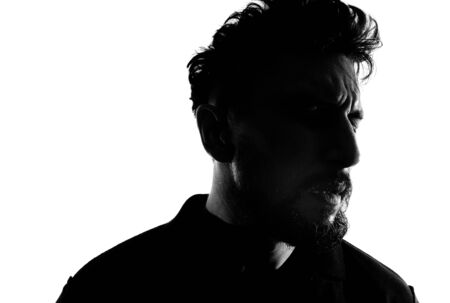 Dramatic profile portrait of male person over white