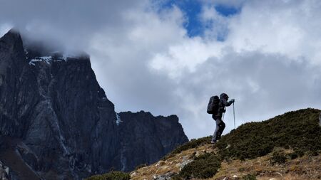 Man in hike on the top of the mountain, walking up 
