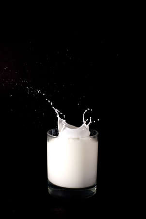 Milk in a glass splashingの写真素材