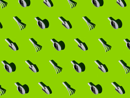 Gardening and time to plant vegetables texture. Small garden hand tools with hard lights on green background.の写真素材