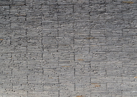 Gray stack slate stone wall texture and background