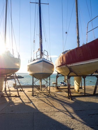 yacht maintenance concept. Winterized yachts standing on land, close-up. Waiting for the new sailing...