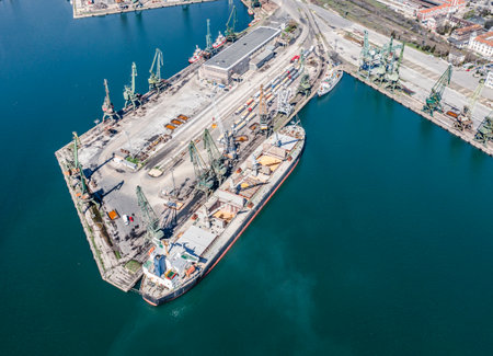 13.04.2023 Varna Black sea Port, Bulgaria - Cargo ship drain Sludge Sewage water or Chemical Waste to the Ocean sea during loading in portのeditorial素材