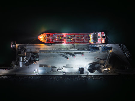 Top down View of Port Tanker and Grain Silos. High oleic sunflower oil is loaded from tanker trucks onto a tanker ship.の写真素材