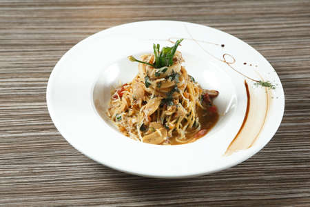 spaghetti with basil garnishの写真素材