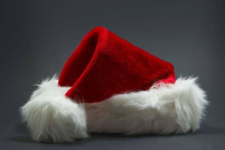 red and white santa hat on grey background