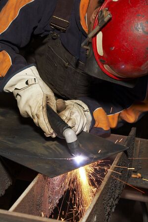welder at shipyard working on steel project