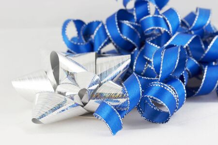 blue and silver ribbon and bow on white backgroundの写真素材