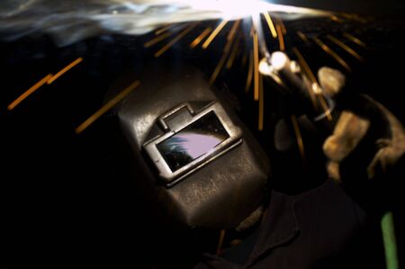 a welder at shipyard working at nightの写真素材